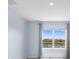Bedroom features a neutral color scheme and a window with a lovely outside view at 33369 Hamilton Hill Ln, Wesley Chapel, FL 33545