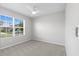 Neutral bedroom with a ceiling fan and a window providing natural light at 33369 Hamilton Hill Ln, Wesley Chapel, FL 33545