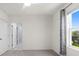 Bedroom featuring a window, large closet, light-colored carpet, and window with a view of the outdoors at 33369 Hamilton Hill Ln, Wesley Chapel, FL 33545