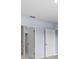 Hallway featuring multiple doorways providing seamless access throughout this home at 33369 Hamilton Hill Ln, Wesley Chapel, FL 33545