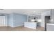 Spacious eat-in kitchen with blue walls, light cabinetry, stainless steel appliances, and tile flooring at 33369 Hamilton Hill Ln, Wesley Chapel, FL 33545