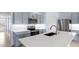 Modern kitchen features stainless steel appliances, stylish gray cabinets, and a spacious quartz island at 33369 Hamilton Hill Ln, Wesley Chapel, FL 33545
