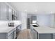 Well-lit kitchen showcasing stainless steel appliances, a large island, and ample counter space at 33369 Hamilton Hill Ln, Wesley Chapel, FL 33545