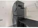 Modern side by side washer and dryer with metal shelving and folding table at 33369 Hamilton Hill Ln, Wesley Chapel, FL 33545