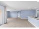 Open-concept living room features neutral tile floors, light blue walls, recessed lighting and lots of natural light at 33369 Hamilton Hill Ln, Wesley Chapel, FL 33545