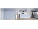 Open-concept living space with stainless steel kitchen appliances, light blue walls and neutral tile floors at 33369 Hamilton Hill Ln, Wesley Chapel, FL 33545