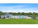 Beautiful community pool with lounge chairs, umbrellas, and a clubhouse overlooking a pond at 33369 Hamilton Hill Ln, Wesley Chapel, FL 33545