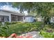 Serene backyard featuring a lush lawn, mature trees, and a cozy screened-in patio at 34811 Arbor Green Pl, Zephyrhills, FL 33541
