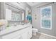 Bathroom features a large vanity mirror, white cabinets and neutral walls at 34811 Arbor Green Pl, Zephyrhills, FL 33541