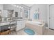 Bathroom featuring a bathtub, white cabinets, and a large vanity with a make up chair at 34811 Arbor Green Pl, Zephyrhills, FL 33541