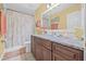 Bathroom features a granite countertop vanity and a floral shower curtain at 34811 Arbor Green Pl, Zephyrhills, FL 33541
