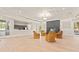 Inviting common area with a fireplace, comfortable seating, and views of the well-kept grounds at 34811 Arbor Green Pl, Zephyrhills, FL 33541