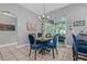 Eat-in kitchen dining area featuring a modern chandelier and sliding doors to the screened in lanai at 34811 Arbor Green Pl, Zephyrhills, FL 33541