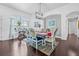 Elegant dining room with a chandelier, colorful decor, and a view of the lush backyard at 34811 Arbor Green Pl, Zephyrhills, FL 33541