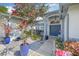 Charming home entrance with colorful landscaping, double doors, and a welcoming walkway at 34811 Arbor Green Pl, Zephyrhills, FL 33541