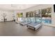 Well-equipped gym featuring modern treadmills and large windows with a view of the community pool at 34811 Arbor Green Pl, Zephyrhills, FL 33541