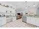 Well-lit kitchen with stainless appliances, ample counter space, and adjacent dining area with seating at 34811 Arbor Green Pl, Zephyrhills, FL 33541