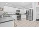 Modern kitchen with stainless steel appliances, granite countertops, and ample cabinet space for storage at 34811 Arbor Green Pl, Zephyrhills, FL 33541