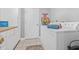 Bright laundry room with white cabinets, butcher block countertop, and modern washer and dryer at 34811 Arbor Green Pl, Zephyrhills, FL 33541