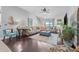Comfortable living room features a large sectional sofa, vaulted ceilings, and dark wood floors at 34811 Arbor Green Pl, Zephyrhills, FL 33541