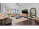 Spacious living room with a plush sectional, large TV, and stylish decor, perfect for entertaining at 34811 Arbor Green Pl, Zephyrhills, FL 33541