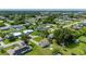 Drone view of the house, showing the backyard, and surrounding neighborhood full of mature trees at 3513 Syracuse St, Port Charlotte, FL 33952