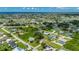 Aerial view of property showcasing the home, surrounding neighborhood and distant ocean view at 3513 Syracuse St, Port Charlotte, FL 33952