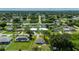 Aerial view of the property and surrounding neighborhood with mature trees and grassy lawns at 3513 Syracuse St, Port Charlotte, FL 33952