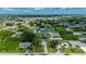 Bird's eye view of property in a neighborhood with lush trees and proximity to town at 3513 Syracuse St, Port Charlotte, FL 33952