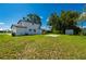 Spacious backyard featuring lush green grass and mature trees, perfect for outdoor activities at 3513 Syracuse St, Port Charlotte, FL 33952