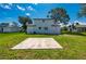 Large concrete slab in a backyard surrounded by a well-manicured lawn on a sunny day at 3513 Syracuse St, Port Charlotte, FL 33952