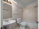 Bathroom with ceramic tile surround, toilet, combination tub and shower and pedestal sink at 3513 Syracuse St, Port Charlotte, FL 33952