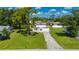 Charming two-story home with a well-manicured lawn and mature landscaping and a large driveway at 3513 Syracuse St, Port Charlotte, FL 33952
