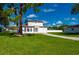 Charming two-story home with a well-manicured lawn and mature landscaping and a large driveway at 3513 Syracuse St, Port Charlotte, FL 33952