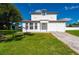 Charming two-story home with a freshly manicured lawn and a well-lit exterior at 3513 Syracuse St, Port Charlotte, FL 33952