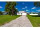 Charming two-story home with a well-manicured lawn and mature landscaping and a large driveway at 3513 Syracuse St, Port Charlotte, FL 33952