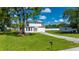 Well-maintained two-story home with a lush lawn and convenient driveway access at 3513 Syracuse St, Port Charlotte, FL 33952