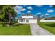 Charming two-story home with a well-manicured lawn and mature landscaping and a large driveway at 3513 Syracuse St, Port Charlotte, FL 33952