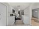 Updated kitchen with modern stainless appliances, white cabinets, and tile floors at 3513 Syracuse St, Port Charlotte, FL 33952