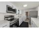 Clean, bright kitchen featuring modern stainless steel appliances and white cabinetry at 3513 Syracuse St, Port Charlotte, FL 33952