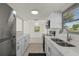 Well-lit, updated kitchen with stainless steel appliances, white cabinets, and a double sink at 3513 Syracuse St, Port Charlotte, FL 33952