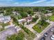 An aerial view of a neighborhood featuring a charming home with a brick roof, and a long driveway at 425 49Th N St, St Petersburg, FL 33710