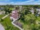 Aerial view of a single-Gathering home featuring a red tile roof, mature trees, and a white picket fence at 425 49Th N St, St Petersburg, FL 33710
