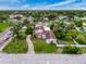 Wide aerial view shows home with red tile roof, mature trees, and proximity to neighborhood at 425 49Th N St, St Petersburg, FL 33710