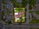 An aerial view of a charming property with lush trees, a home with a brick roof, and a driveway at 425 49Th N St, St Petersburg, FL 33710