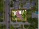 An aerial view of a landscaped property featuring a charming home, mature trees, and a spacious driveway at 425 49Th N St, St Petersburg, FL 33710