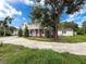 Charming two-story home featuring a large yard with mature trees at 425 49Th N St, St Petersburg, FL 33710