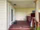 Cozy back porch featuring weathered wood deck, decorative railings, and covered ceiling at 425 49Th N St, St Petersburg, FL 33710