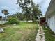 Backyard with mature trees and lawn at 425 49Th N St, St Petersburg, FL 33710