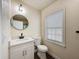 Bright bathroom features a modern vanity with sleek fixtures and a round mirror at 425 49Th N St, St Petersburg, FL 33710